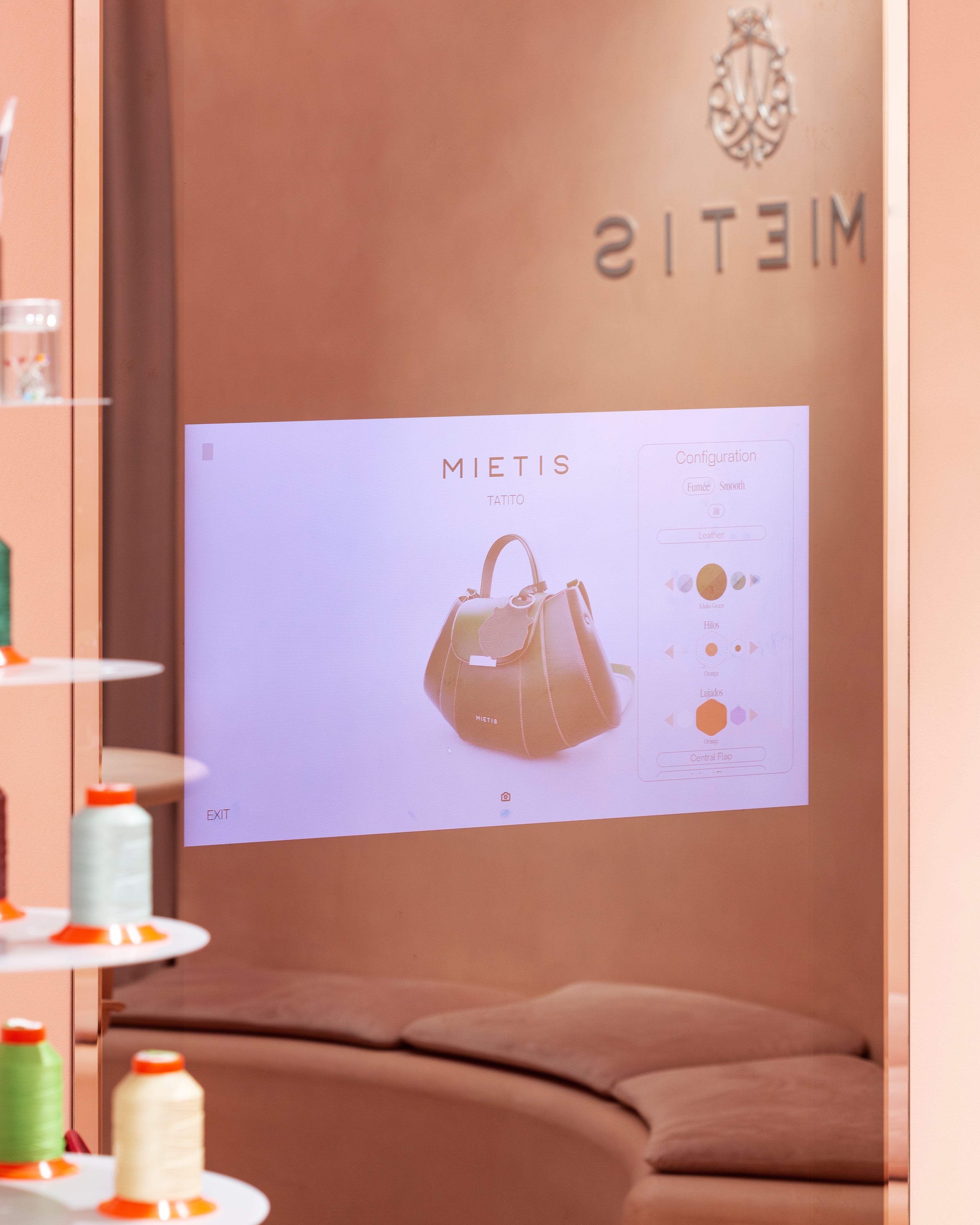 Handbag design layout featuring premium hardware options and colorful leather samples at the Mietis Barcelona studio.